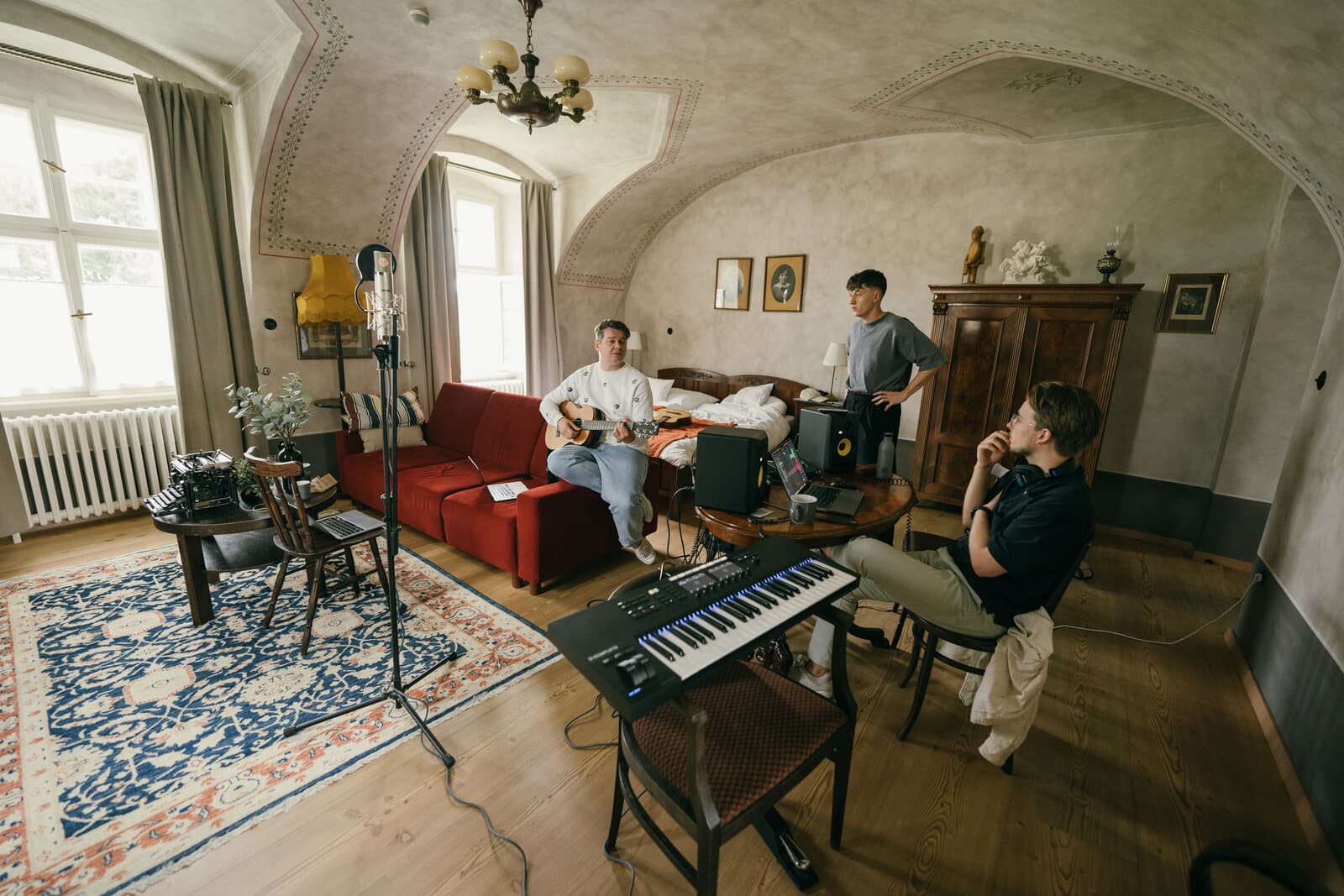 An artist writing with collaborators in a studio